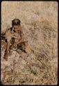 Food Gathering, General: Woman sitting in grass, gathering tsi