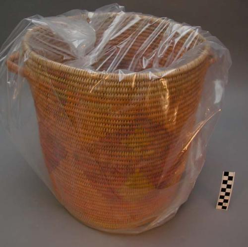 Large cylindrical utility basket with side handles. Coil technique. Made of be