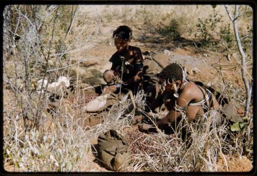 Food Gathering, Tsi: Two women sitting next to piles of tsi