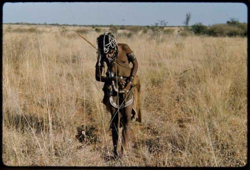 Food Gathering, Tsi: Girl from Band 10 wearing white bead hair ornaments, standing in the tsi area