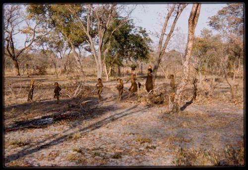 Women and children returning with water