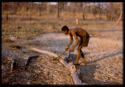 Man cutting wood (out of focus)