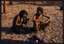 Two women smoking a big horn water pipe