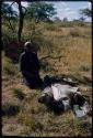 Philip Hameva sitting next to a pig that he and Manuel skinned