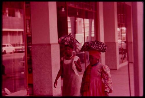 Two local women walking with bundles on their heads