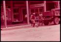 Young prisoners in red jerseys working on a city street