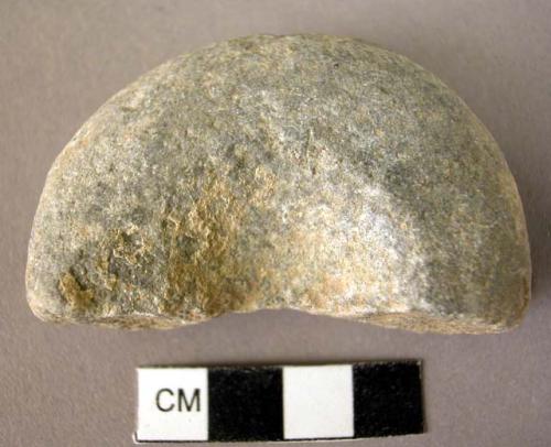 Fragment of abrading stone, pitted on each side