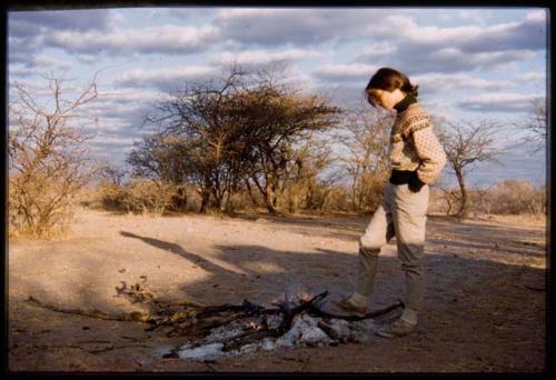 Deborah Marshall standing at campfire