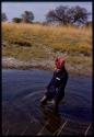 Kernel Ledimo wading in the river, showing knee-deep depth of ford