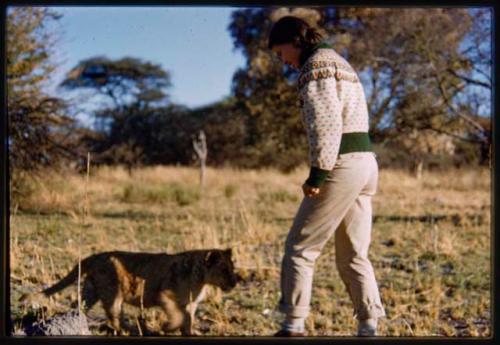 Deborah Marshall and a lion cub standing next to each other