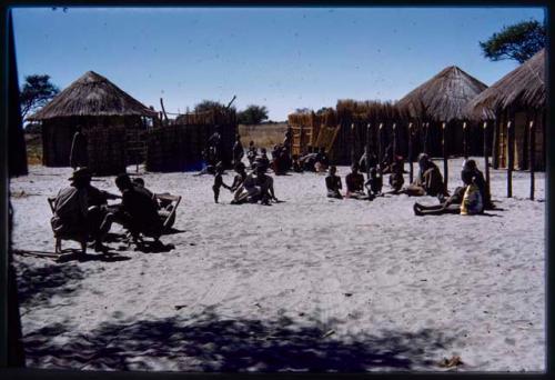 Group of people in village, sitting around