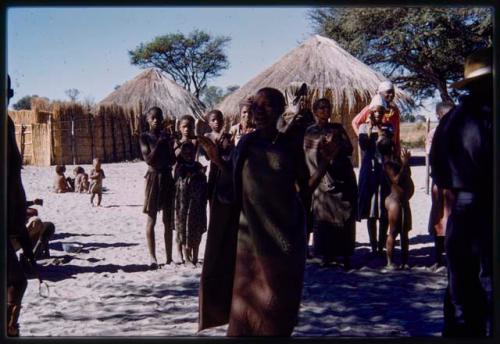 Dancing woman, with a group of people clapping