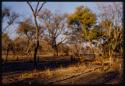 Fire in a veld, children standing near by