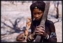 Girl holding onto a tree branch, close up view