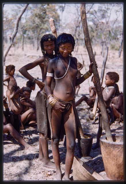 Two girls standing, other people in background