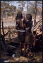 Two girls standing, seen from behind