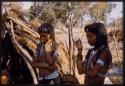 Two girls standing by a skerm, close up view