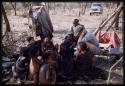 Nicholas England and Kernel Ledimo sitting with a group of people