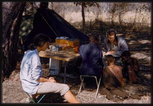 Nicholas England and Kernel Ledimo sitting with Hu/Na and Kumsa, Deborah Marshall sitting to the side