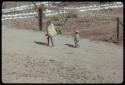 Two children walking on a road