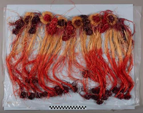 Kiekie of red and purple dyed and natural plant fiber