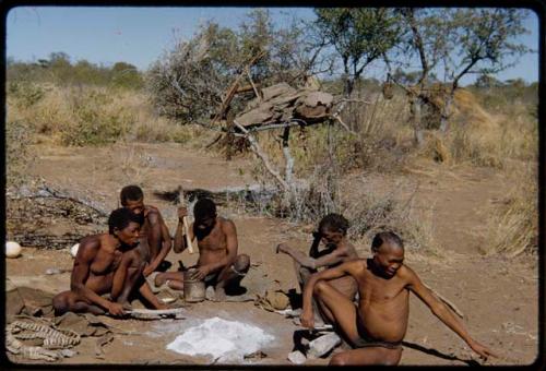 Groups: Men sitting with "Old Gau" at his dwelling place, including "Old ≠Toma," ≠Gao, "Old /Gaishay," and /Qui (Gau's son-in-law); Gau cracking nuts with a fire paddle