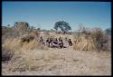 Groups, Extended Family: "Gao Hunchback" squatting (right), with his extended family (Band 11) sitting around him, distant view