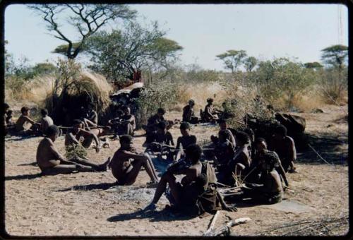 Groups, Extended Family: "Gao Medicine" sitting with members of his family, including N!ai playing //guashi (right), "Old /Gaishay" (left), "Crooked /Qui," //Khuga holding her baby Bau, /Gaishay (Gao Medicine's son) and /Naoka