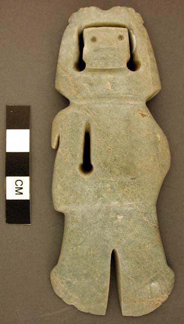 Split jade celt, human representation with skeletal face