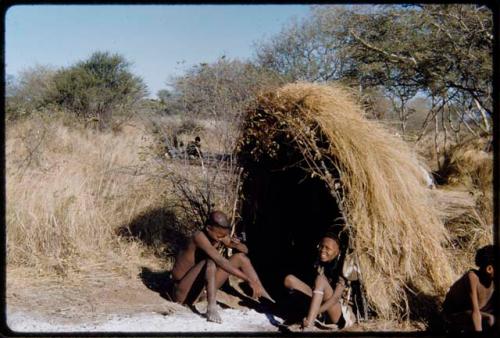 Groups, "Nuclear Family": Tsamgao and Bau (daughter of /Ti!kay) sitting in front of a skerm