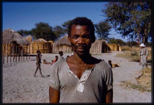 Man standing, with people in the background