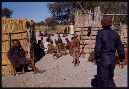 Group of people at village entrance, with Kernel Ledimo in the foreground