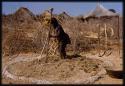 Woman threshing, in profile