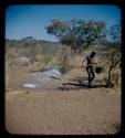 Man walking with Ovambo pot on stick