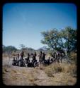 Group of men performing a curing dance, with a circle of women sitting