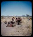 Group of men performing a curing dance, with a circle of women sitting