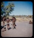 Group of men standing during a curing dance