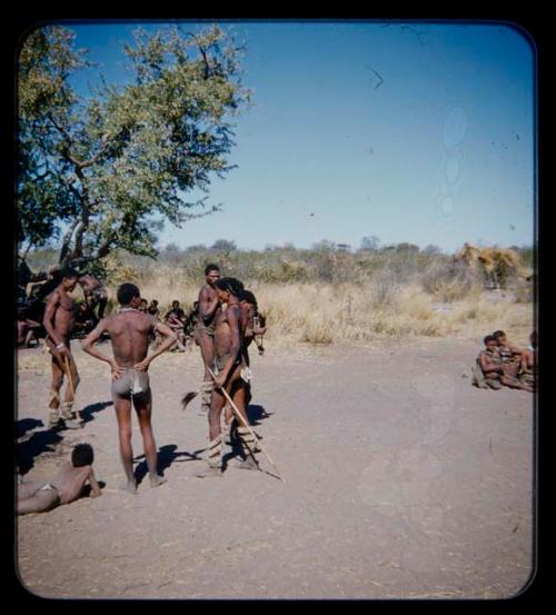 Group of men standing during a curing dance