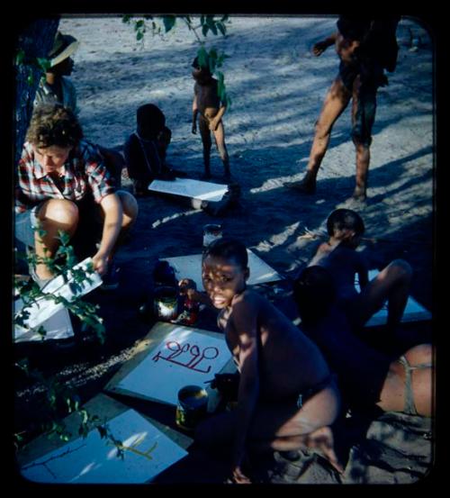 "≠Gao Lame" and other children painting, with Elizabeth Marshall Thomas sitting near them