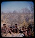 Group of Ju/'hoan women and girls sitting by a skerm