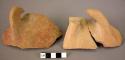 4 potsherds with handle fragments; 1 pottery handle fragment - buff and reddish