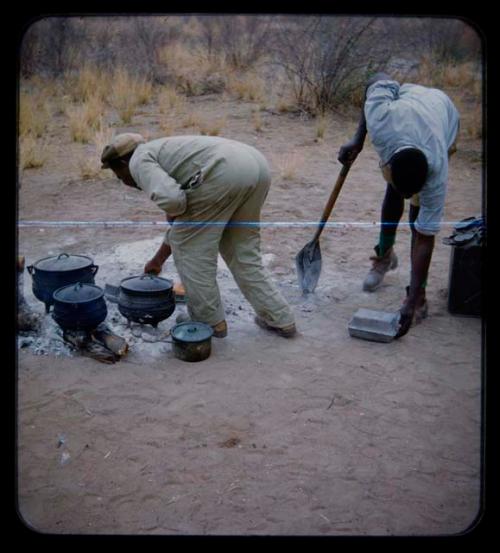 Philip Hameva cooking with his helper [streaked]