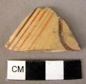 Pottery cylix fragment with part of conventionalized naturalistic pattern