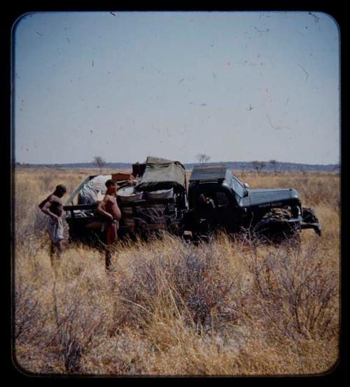 Man standing next to an expedition member near a truck