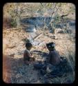 Food, Preparation: Girl and a child eating, sitting by ashes