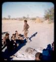 Food, Meat: Man walking away from meat, with other people sitting behind him