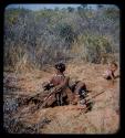 Food Gathering, Children: Woman sitting by a hole, with two children nearby