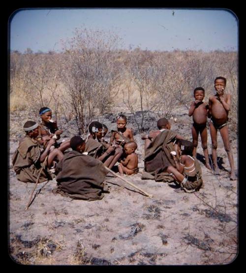 Food Gathering, Water Root: Group of women and children eating roots