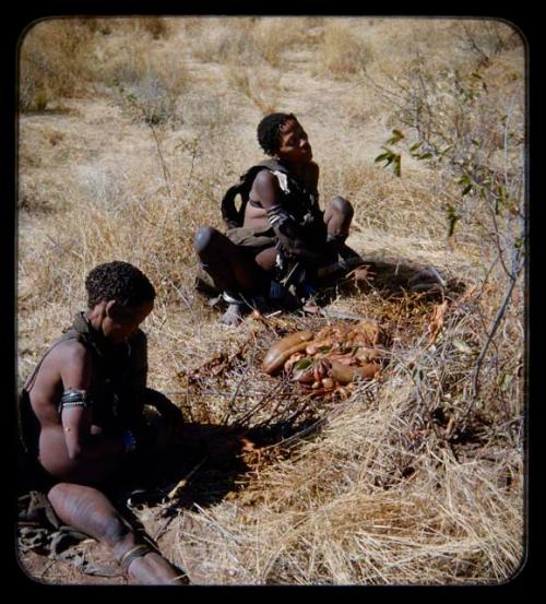 Food Gathering, "Manghettis": Two women sitting by a pile of animal entrails