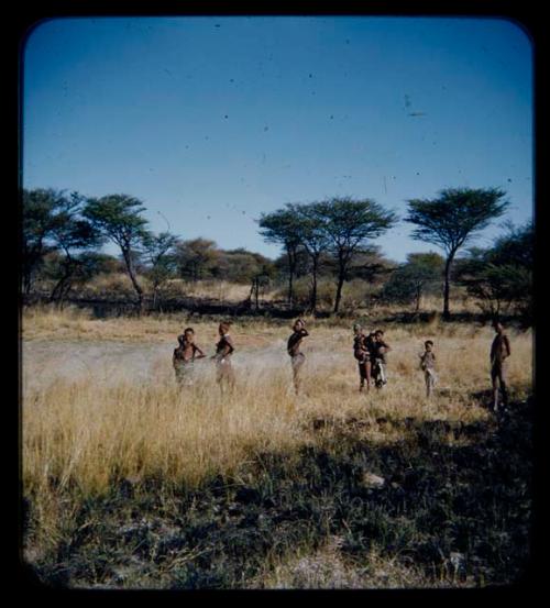 Food Gathering, Men: Group of people standing at the edge of forest